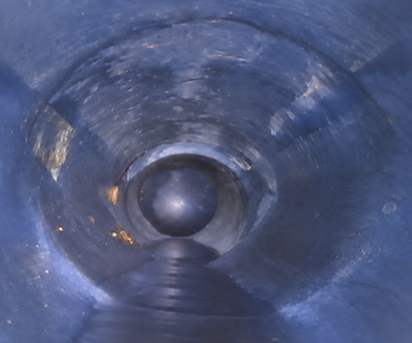 Interior camera view of a sewer pipe after trenchless CIPP lining, showing a smooth new liner inside the old pipe